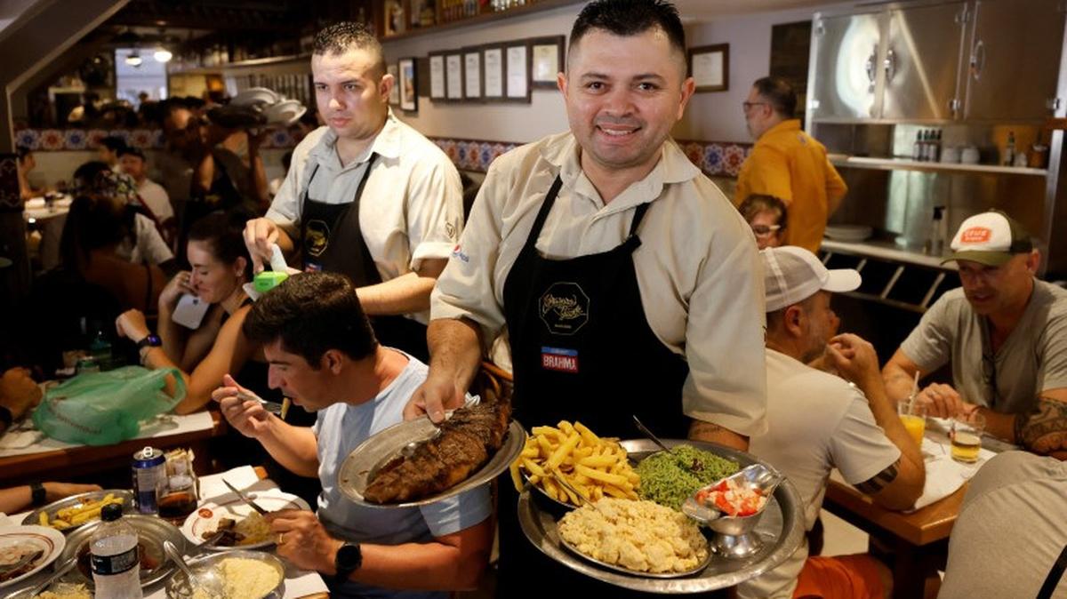 A waiter shows food at Braseiro da Gavea in Rio de Janeiro, Brazil, February 23, 2025. REUTERS/Jorge Silva