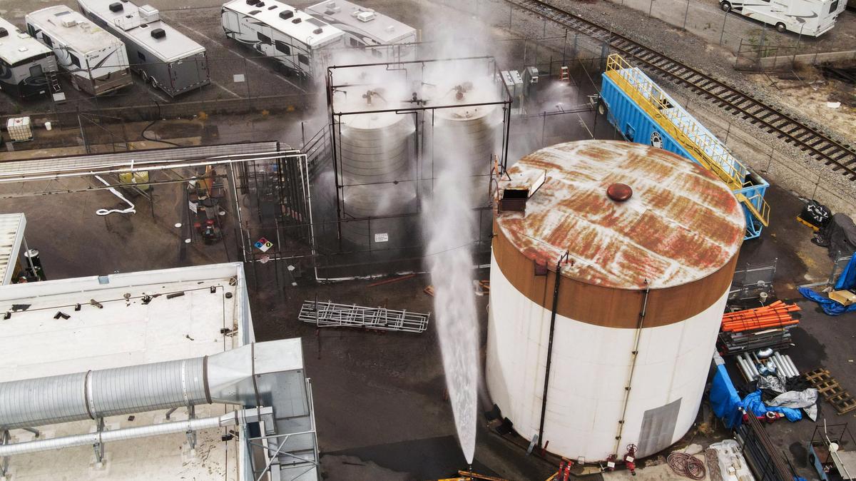 A drone view shows water being sprayed during a chemical incident involving a leaking tank of methyl methacrylate, a flammable liquid used in the aerospace industry, forcing an evacuation in the surrounding area, in Garden Grove, California, U.S., May 23, 2026. REUTERS/David Swanson