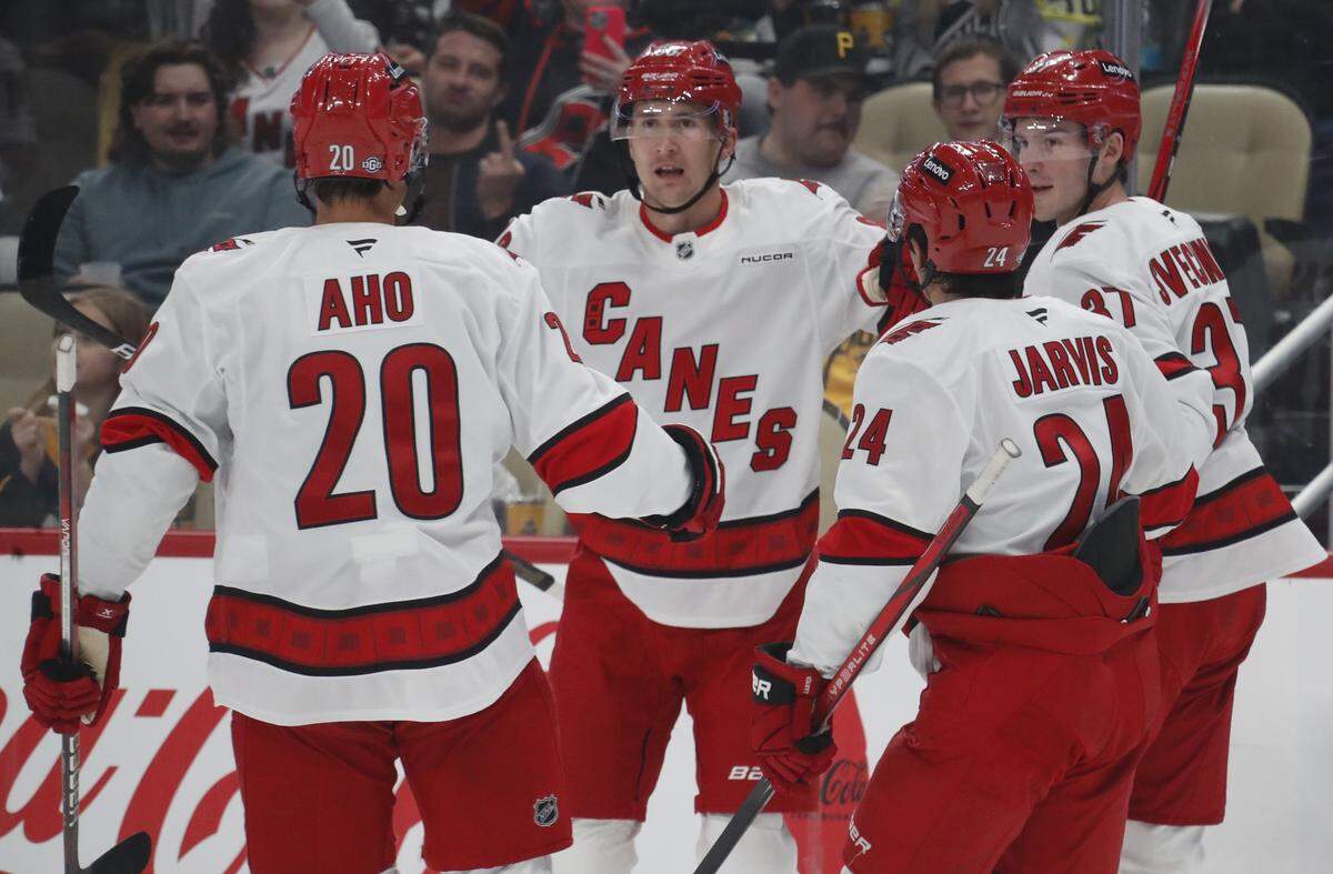 Oct 18, 2024; Pittsburgh, Pennsylvania, USA; Carolina Hurricanes center Sebastian Aho (20) and center Seth Jarvis (24) and right wing Andrei Svechnikov (37) congratulate center Martin Necas (88) on his goal against the Pittsburgh Penguins during the second period at PPG Paints Arena.