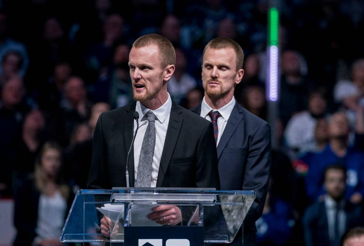  Twin brothers Daniel Sedin (22) and Henrik Sedin (33) of Sweden speak while being honored in a ceremony held prior to a game between the Vancouver Canucks and Chicago Blackhawks. Bob Frid-Imagn Images