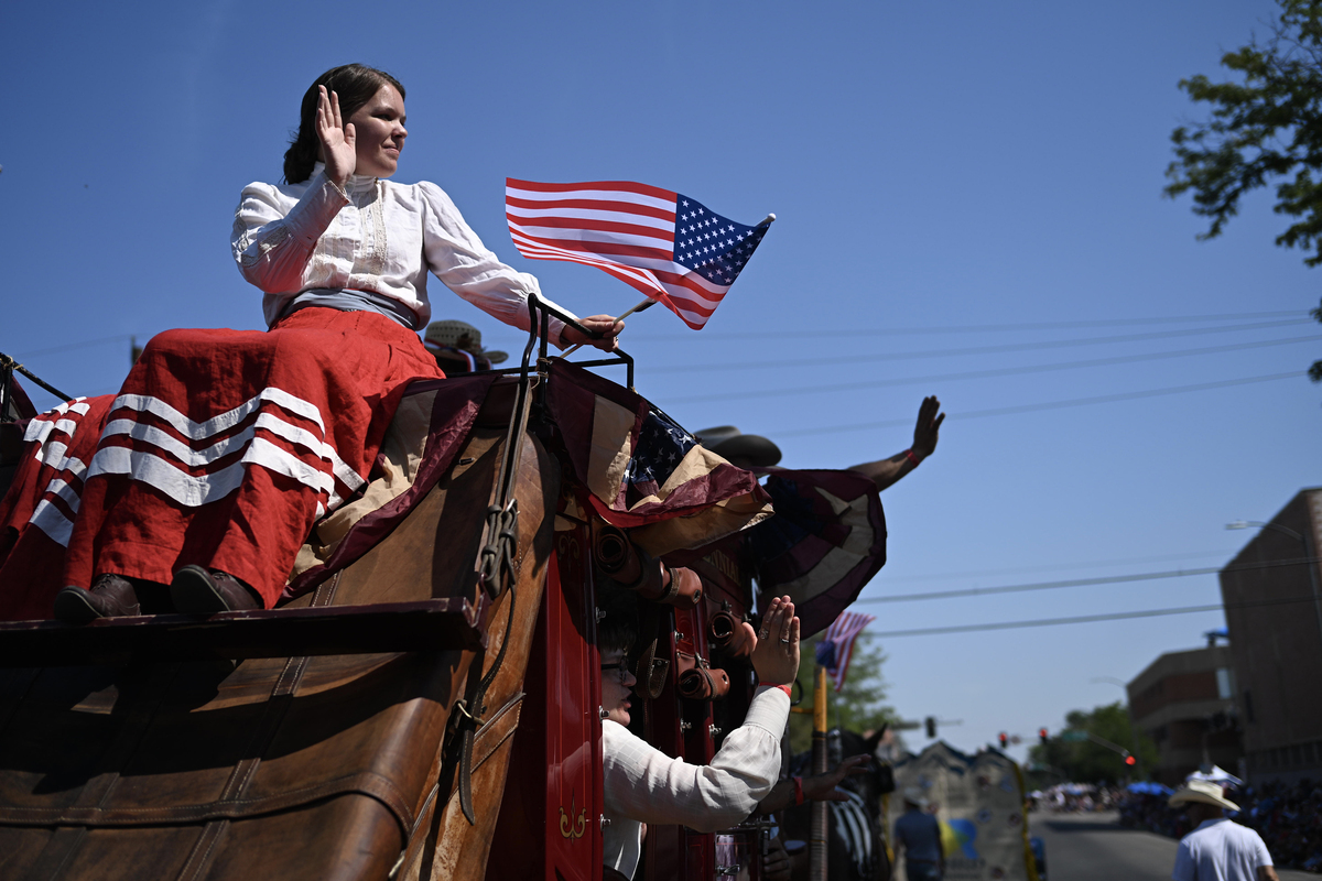 A stagecoach passes by during the Greeley Stampede's Independence Day parade in Greeley, Colo., July 4, 2026. America celebrates the 250th anniversary of its independence today, with people from one end of the country to the other marking the milestone with fireworks, parades and concerts. (Mark Makela/The New York Times)
