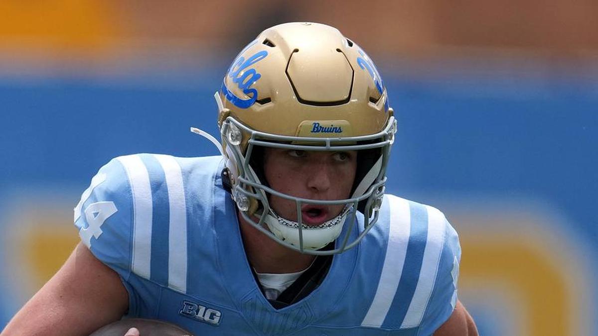  May 2, 2026; Pasadena, CA, USA; UCLA Bruins quarterback y Dieffenbach (14) carries the ball during the spring game at Rose Bowl. Mandatory Credit: Kirby Lee-Imagn Images | Kirby Lee-Imagn Images 