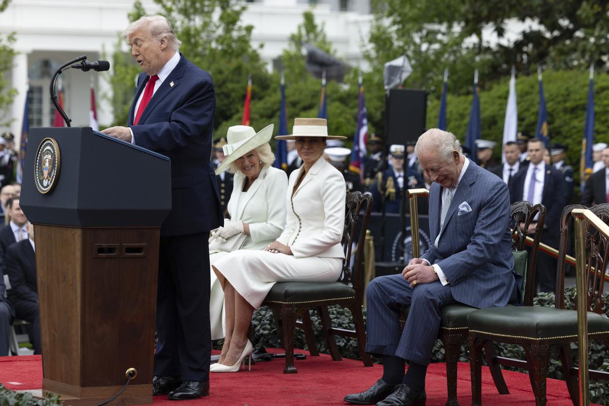 King Charles III smiles as President Donald Trump speaks during an arrival ceremony on the South Lawn of the White House in Washington, on Tuesday, April 28, 2026. From left: Trump, Queen Camilla, first lady Melania Trump and King Charles III. (Anna Rose Layden/The New York Times)