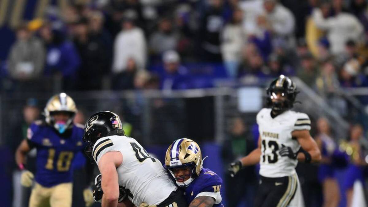  Nov 15, 2025; Seattle, Washington, USA; Washington Huskies linebacker Deven Bryant (17) tackles Purdue Boilermakers tight end Christian Moore (44) during the second half at Husky Stadium. Mandatory Credit: Steven Bisig-Imagn Images | Steven Bisig-Imagn Images 