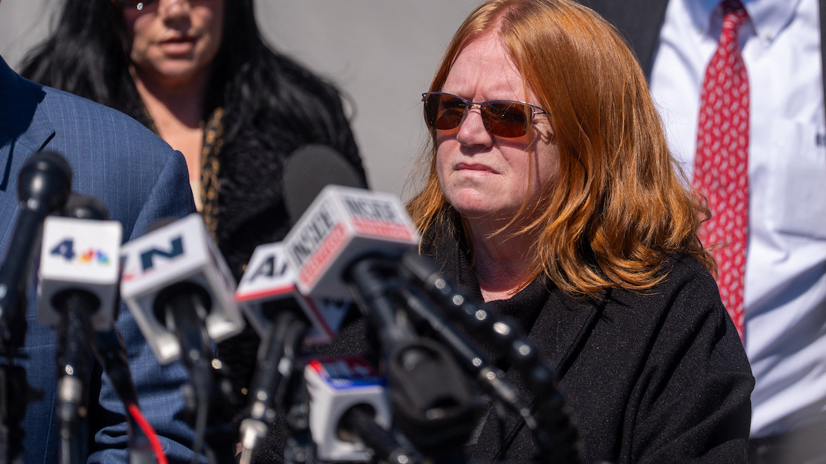 Asa Ellerup listens to Attorney Robert Macedonio speak to the media outside Suffolk County Court after her estranged husband Rex Heuermann pleaded guilty to killing eight women in Riverhead, New York on April 8, 2026. The Gilgo Beach serial killings refer to a series of murders discovered on Long Island in 2010–2011, with Rex Heuermann arrested in 2023 and charged in several of the killings. (Photo by David Dee Delgado / AFP)