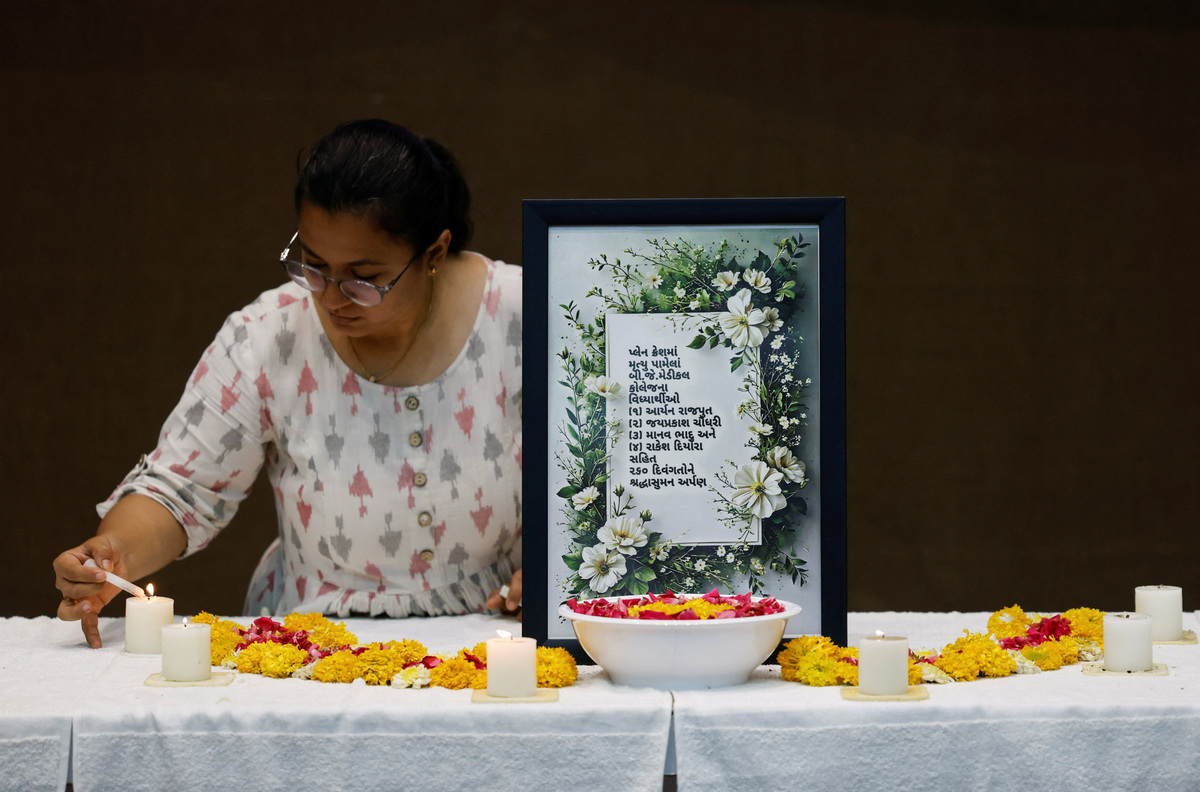 A woman lights a candle as she attends the memorial ceremony during the first anniversary of Air India Boeing 787-8 Dreamliner crash on June 12, 2025, at B.J. Medical College and Civil hospital in Ahmedabad, India, June 12, 2026. REUTERS/Amit Dave