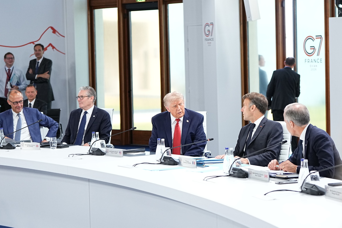 President Donald Trump, center, and President Emmanuel Macron of France speak during a working session of the G7 Summit in Evian-les-Bains, France, on Wednesday, June 17, 2026. From left: Chancellor Friedrich Merz of Germany, Prime Minister Keir Starmer of the United Kingdom, Trump, Macron, Prime Minister Mark Carney of Canada, and Prime Minister Giorgia Meloni of Italy. (Haiyun Jiang/The New York Times)