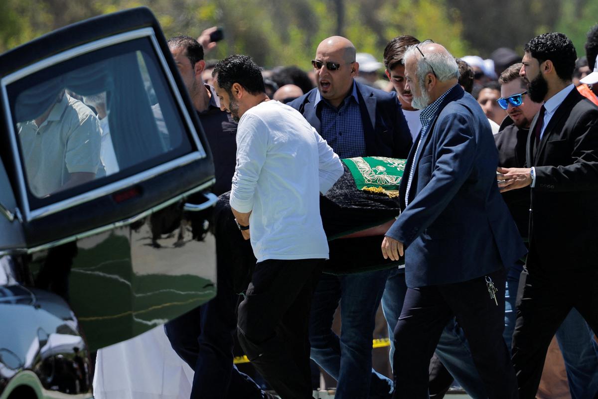 People take the bodies of the victims of a shooting at the Islamic Center back to the hearses, following a prayer service, in San Diego, California, U.S. May 21, 2026.  REUTERS/Mike Blake