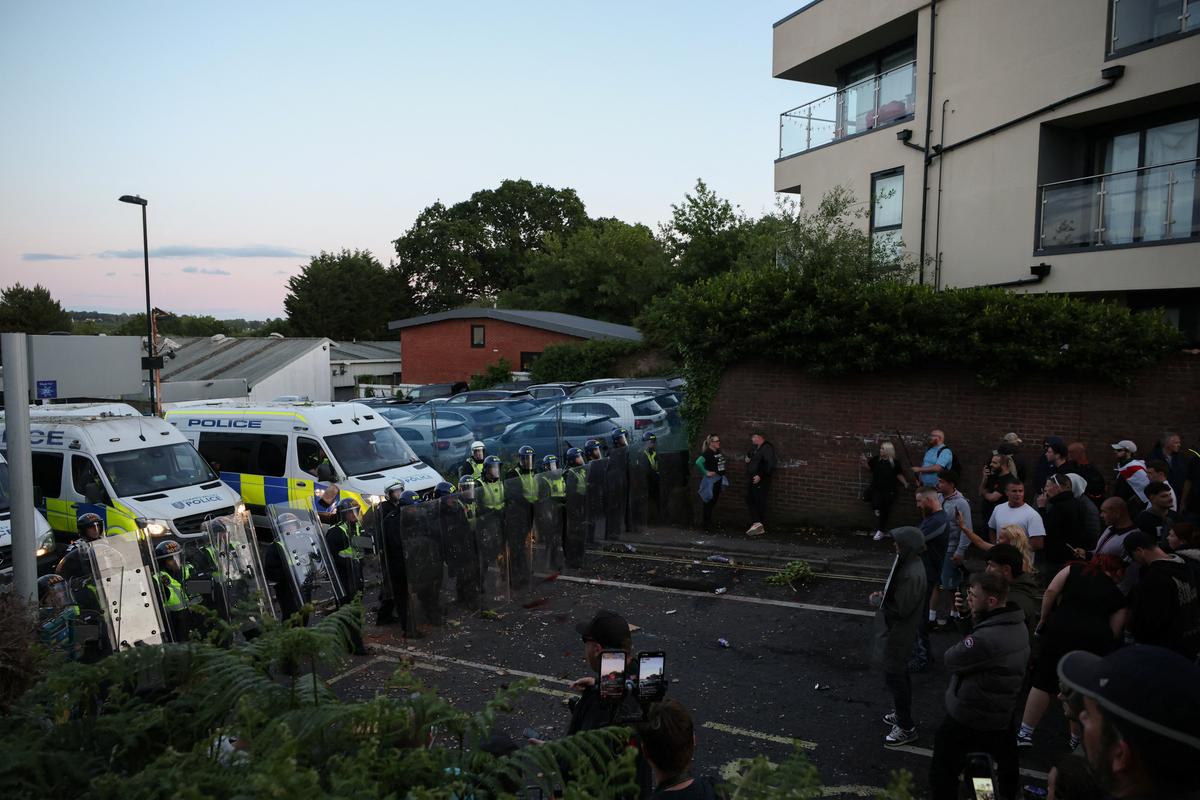 Protesters stand facing police officers during a demonstration following the conviction of Vikrum Digwa for the murder of student Henry Nowak, in Southampton, Britain, June 2, 2026. REUTERS/Isabel Infantes