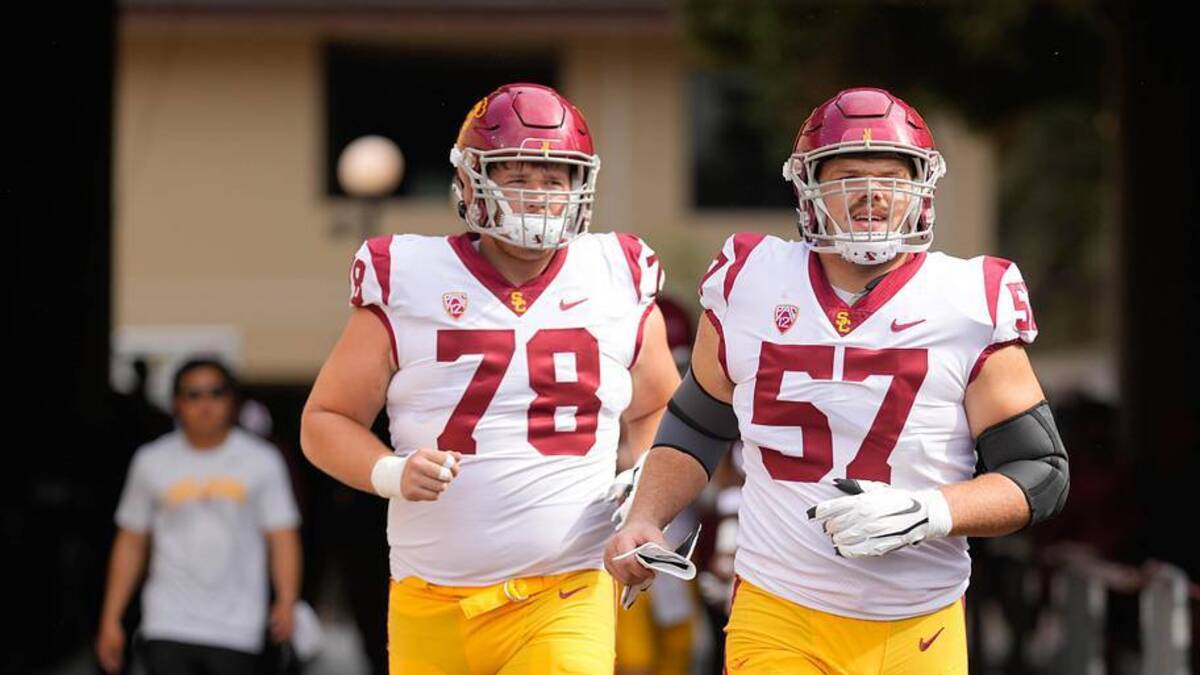 Sep 10, 2022; Stanford, California, USA; USC Trojans offensive linemen Andrew Milek (78) and Justin Dedich (57) jog onto the field for warm ups before the start of the first quarter against the Stanford Cardinal at Stanford Stadium. Mandatory Credit: Stan Szeto-Imagn Images | Stan Szeto-Imagn Images 