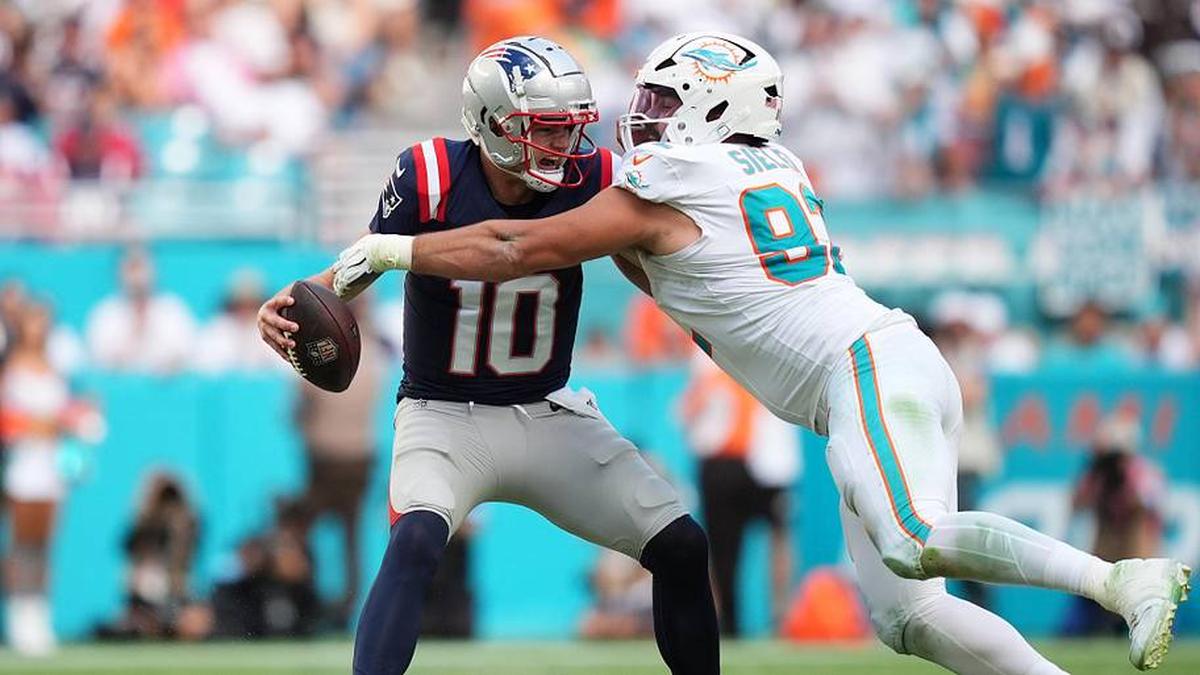  Nov 24, 2024; Miami Gardens, Florida, USA; Miami Dolphins defensive tackle Zach Sieler (92) strip sacks New England Patriots quarterback Drake Maye (10) during the second half at Hard Rock Stadium. Mandatory Credit: Jasen Vinlove-Imagn Images | Jasen Vinlove-Imagn Images 
