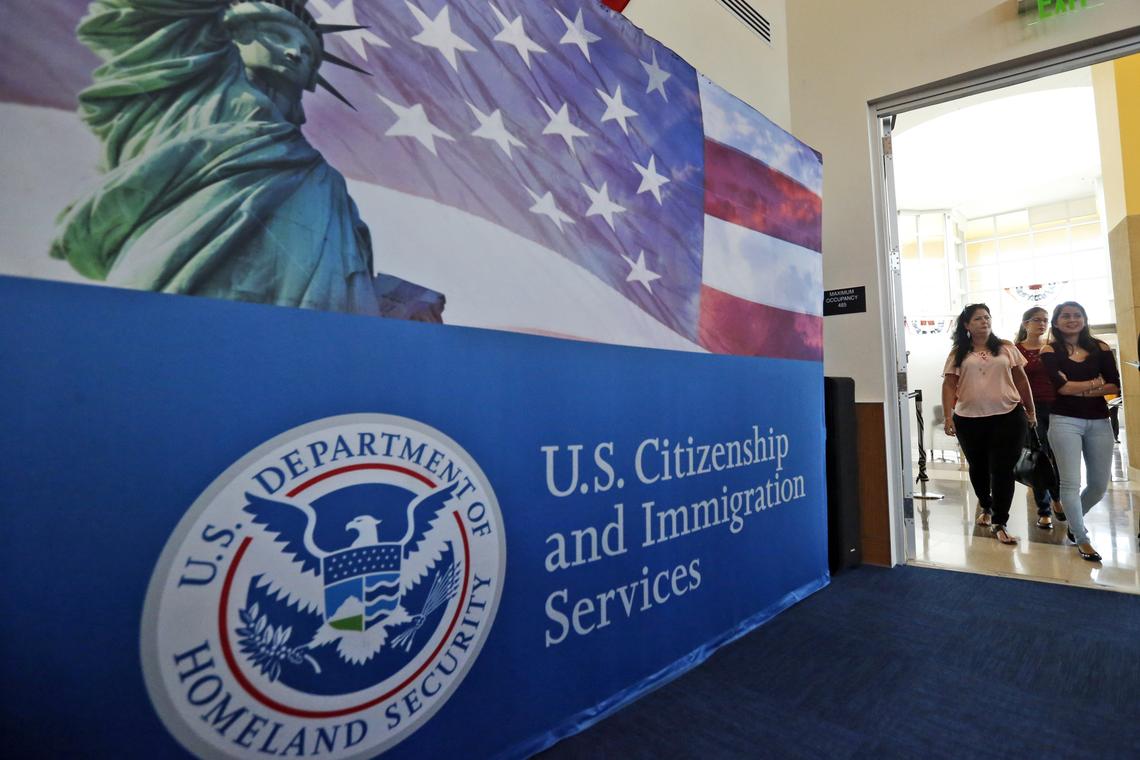  People arrive before the start of a naturalization ceremony at the USCIS Miami Field Office in Miami. 