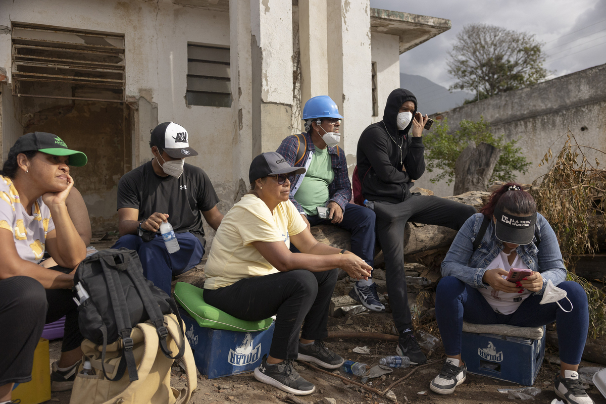 Hiram Villarroel's family and neighbors wait for news as machines dig through the rubble of the building where they lived La Guaira, Venezuela, on July 3, 2026. Six-year-old Villarroel, an aspiring pitcher who had begun playing baseball less than a year ago, is still missing somewhere in the debris of his pancaked apartment building, along with his parents, after two earthquakes struck Venezuela on June 24, 2026. (Fabiola Ferrero/The New York Times)