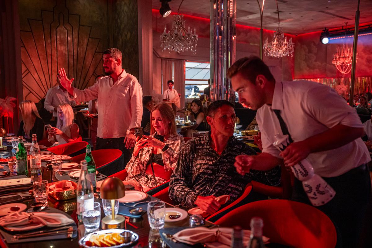 Patros dine at Come Leo Come, a Russian-style supper club catering to expats in Bang Tao, Phuket, Thailand on March 8, 2026. Thousands who fled Russia after the invasion of Ukraine have built an enclave in Phuket, where an air of impermanence hangs over their community. (Lauren DeCicca/The New York Times)..