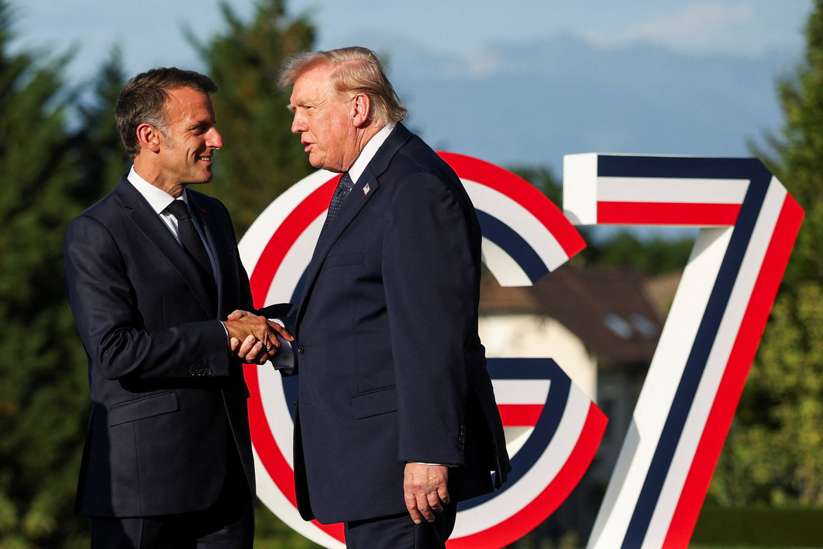 French President Emmanuel Macron greets U.S. President Donald Trump during the G7 summit in Evian-les-Bains, France, June 15, 2026. REUTERS/Isabel Infantes/Pool