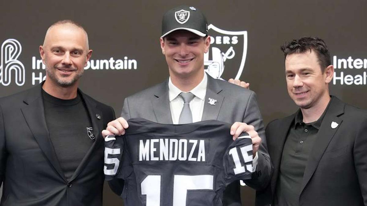  Apr 24, 2026; Henderson, NV, USA; Las Vegas Raiders quarterback Fernando Mendoza (center) poses with general manager John Spytek (left) and head coach Klint Kubiak at introductory press conference at Intermountain Health Performance Center after being selected as the No. 1 pick in the 2026 NFL Draft. Mandatory Credit: Kirby Lee-Imagn Images | Kirby Lee-Imagn Images 
