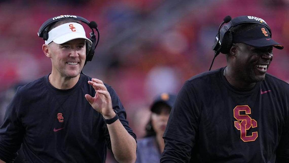  Sep 2, 2023; Los Angeles, California, USA; Southern California Trojans head coach Lincoln Riley (leff) and wide receivers coach Dennis Simmons react against the Nevada Wolf Pack in the second half at United Airlines Field at Los Angeles Memorial Coliseum. Mandatory Credit: Kirby Lee-Imagn Images | Kirby Lee-Imagn Images 