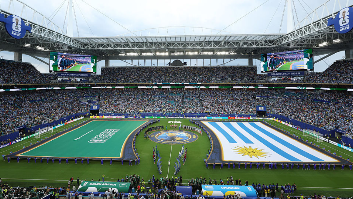 Players and match officials line up before the FIFA World Cup Group H match between Saudi Arabia and Uruguay at Miami Stadium on Monday. Unlike every other participating nation, Saudi Arabia’s flag is never placed on the ground during World Cup ceremonies. Instead, it is always held above the pitch by volunteers.