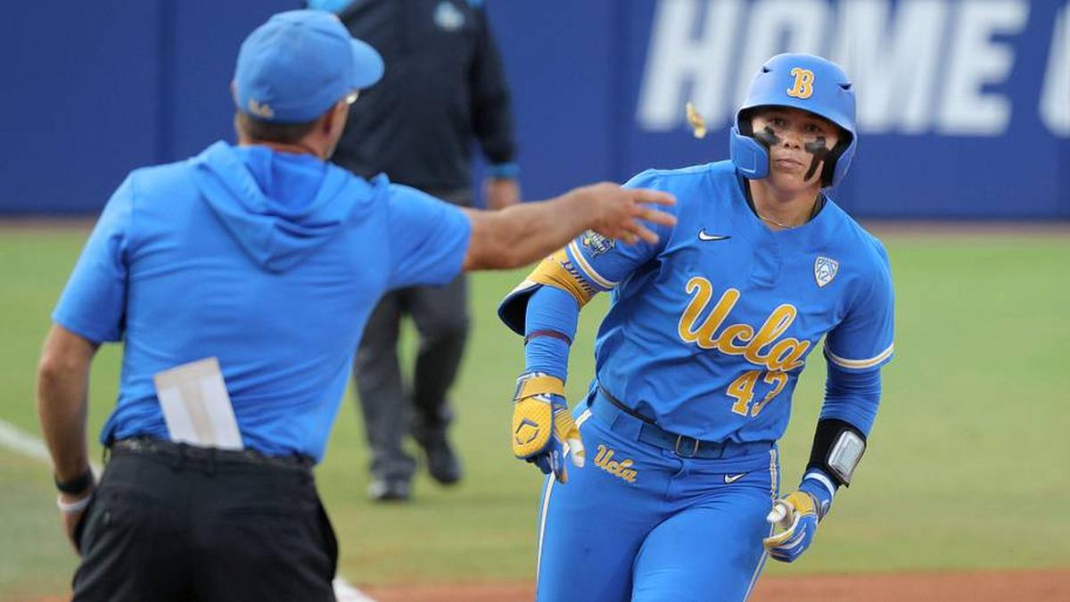  UCLA's Megan Grant (43) is tossed a piece of candy after hitting a home run in the second inning of a Women's College World Series softball game between the Stanford Cardinal and the UCLA Bruins at Devon Park in Oklahoma City, Sunday, June 2, 2024. Stanford won 3-1. | BRYAN TERRY/THE OKLAHOMAN / USA TODAY NETWORK 