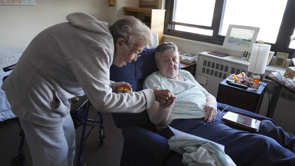 Sister Mary Kay Finneran administering communion to Sister Mary T. Higgins at Kittay Senior Apartments in the Bronx borough of New York on Aug. 28, 2025. An influential order of nuns decided to complete its mission when the last sister dies. The only question left is how to finish well. (Michelle V. Agins/The New York Times)
