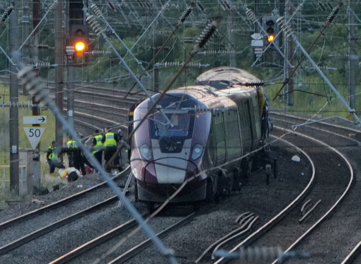 Emergency service workers gather at the scene of a collision involving two trains near Bedford, Britain, June 19, 2026. REUTERS/Stringer
