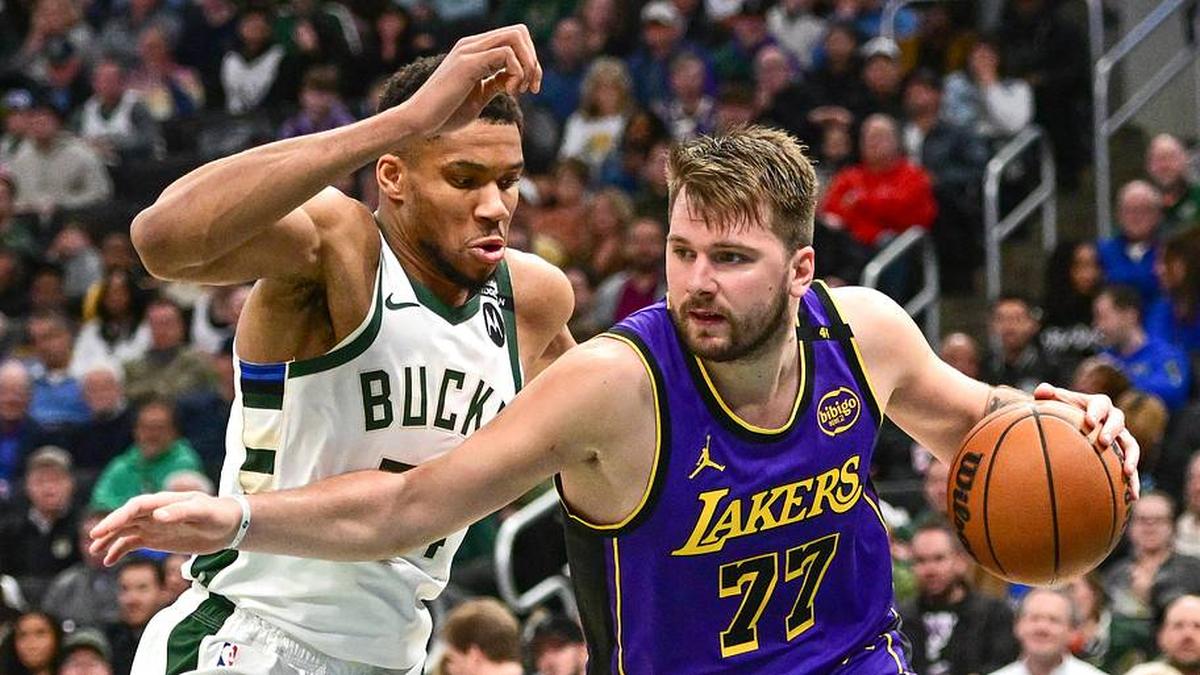  Mar 13, 2025; Milwaukee, Wisconsin, USA; Los Angeles Lakers guard Luka Doncic (77) drives to the basket against Milwaukee Bucks forward Giannis Antetokounmpo (34) in the third quarter at Fiserv Forum. Mandatory Credit: Benny Sieu-Imagn Images | Benny Sieu-Imagn Images 
