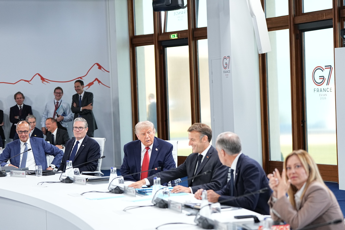 President Donald Trump and President Emmanuel Macron of France speak during a working session of the G7 Summit in Evian-les-Bains, France, on Wednesday, June 17, 2026. From left: Chancellor Friedrich Merz of Germany, Prime Minister Keir Starmer of the United Kingdom, Trump, Macron, Prime Minister Mark Carney of Canada, and Prime Minister Giorgia Meloni of Italy. (Haiyun Jiang/The New York Times)