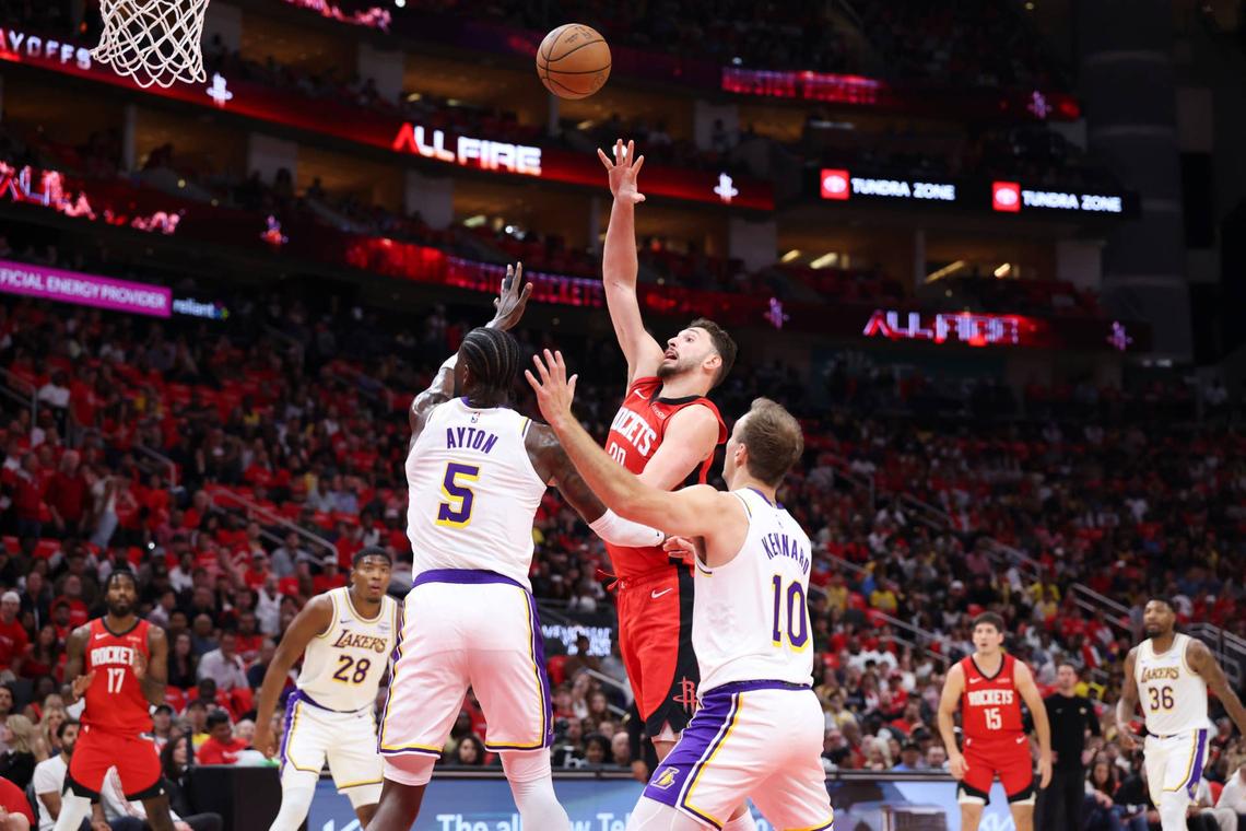  Houston Rockets center Alperen Sengun (28) shoots the ball as Los Angeles Lakers center Deandre Ayton (5) defends. 