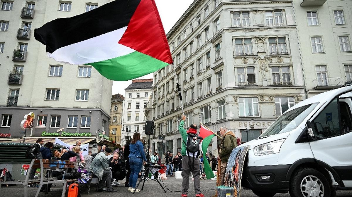 A person holds a Palestinian flag during a protest against the participation of Israel at the Eurovision Song Contest in Vienna, Austria, May 12, 2026. REUTERS/Elisabeth Mandl