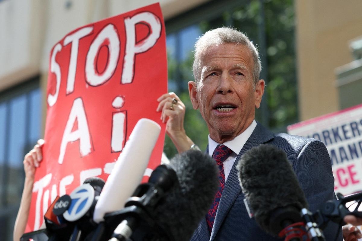 Elon Musk's attorney Marc Toberoff speaks to the press as demonstrators hold placards outside the federal courthouse, as the trial in Elon Musk's lawsuit over OpenAI's for-profit conversion continues, in Oakland, California, U.S., May 18, 2026. REUTERS/Manuel Orbegozo