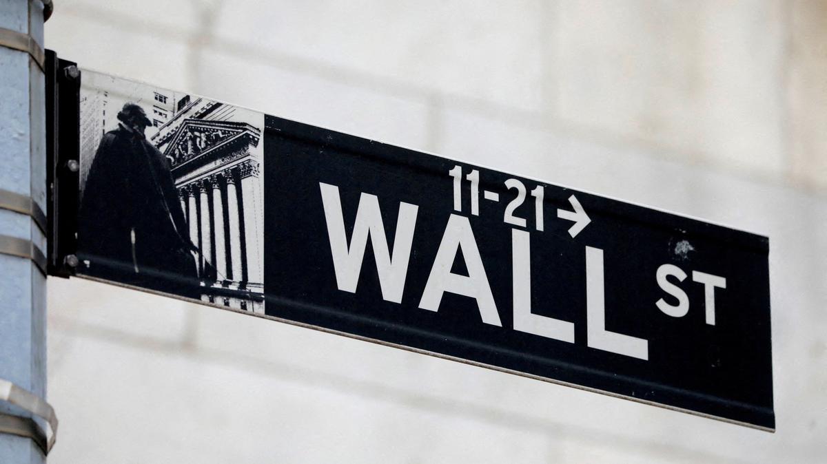 FILE PHOTO: A street sign for Wall Street is seen outside of the New York Stock Exchange (NYSE) in New York City, New York, U.S., June 28, 2021. REUTERS/Andrew Kelly//File Photo