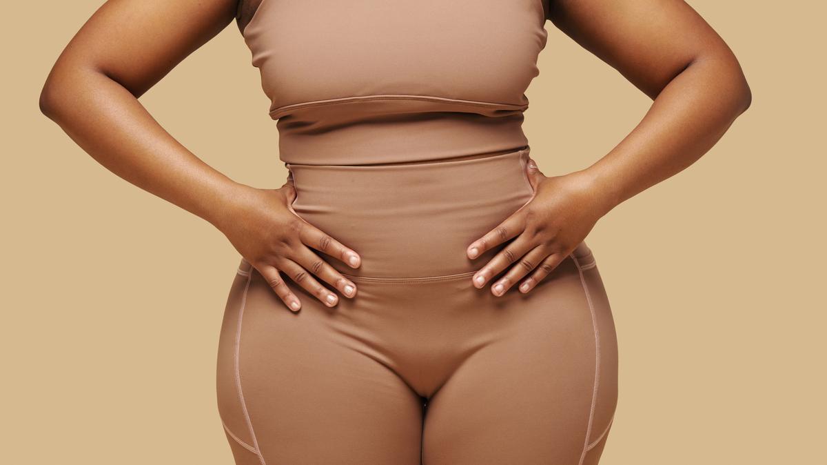 Cropped image of curvy Black woman putting hands on waist