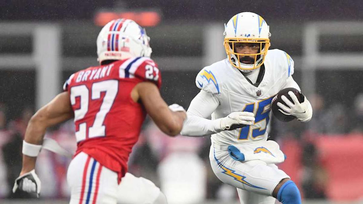  Dec 3, 2023; Foxborough, Massachusetts, USA; Los Angeles Chargers wide receiver Jalen Guyton (15) runs with the ball against New England Patriots cornerback Myles Bryant (27) during the second half at Gillette Stadium. Mandatory Credit: Brian Fluharty-Imagn Images | Brian Fluharty-Imagn Images 