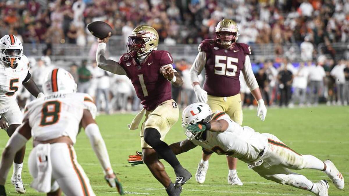  Oct 4, 2025; Tallahassee, Florida, USA; Florida State Seminoles quarterback Tommy Castellanos (1) throws against Miami Hurricanes defensive lineman Akheem Mesidor (3) during the second half at Doak S. Campbell Stadium. Mandatory Credit: Robert Myers-Imagn Images | Robert Myers-Imagn Images 