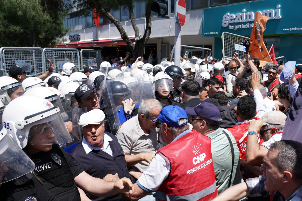 Supporters of Ozgur Ozel, the ousted chairman of the main opposition Republican People’s Party (CHP), scuffle with riot police during a rally while waiting for his arrival in Izmir, Turkey, May 26, 2026. REUTERS/Tolga Uluturk