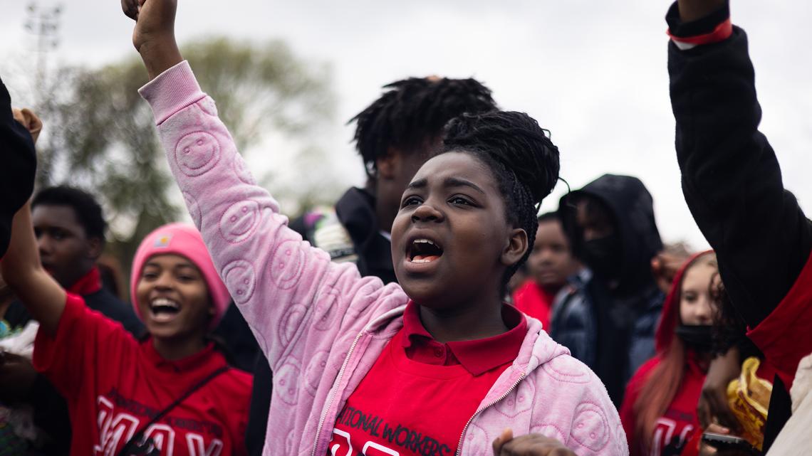 Students at Willa Cather Elementary School hold their fists up to protest school closures as thousands gather at Union Park before marching to Grant Park for the May Day march on May 1, 2025, in Chicago. (Audrey Richardson/Chicago Tribune/TNS)