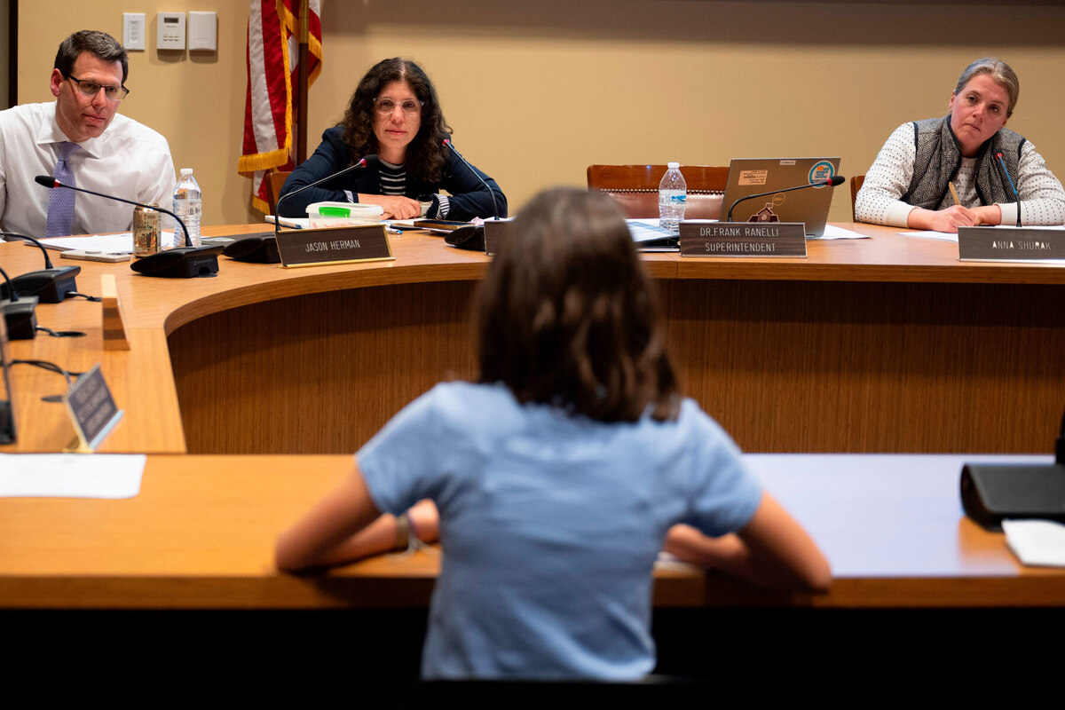  Members of the Lower Merion Board of School Directors speak with a student at a school board meeting, May 11, 2026, in Ardmore, Pa. Credit: Joe Lamberti/AP Photo