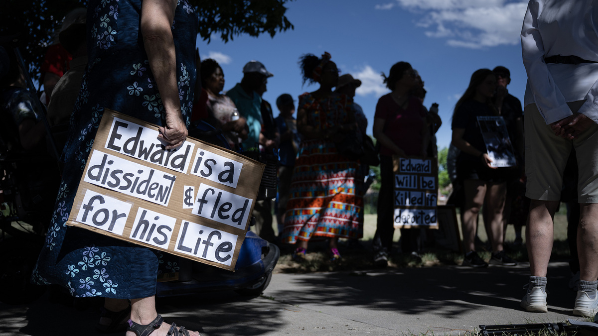 Karen Rider holds a sign during a prayer vigil for the Rev. Edward Nalwamba, a Ugandan national being held in the Aurora ICE Processing Center who is facing deportation after 25 years in the U.S., on Saturday, June 27, 2026, outside the detention center in Aurora, Colo. (Timothy Hurst/The Denver Post/TNS)