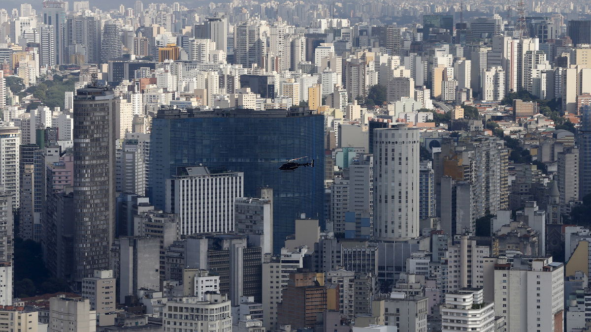 A helicopter flies over the skyline of Sao Paulo April 2, 2015. REUTERS/Paulo Whitaker
