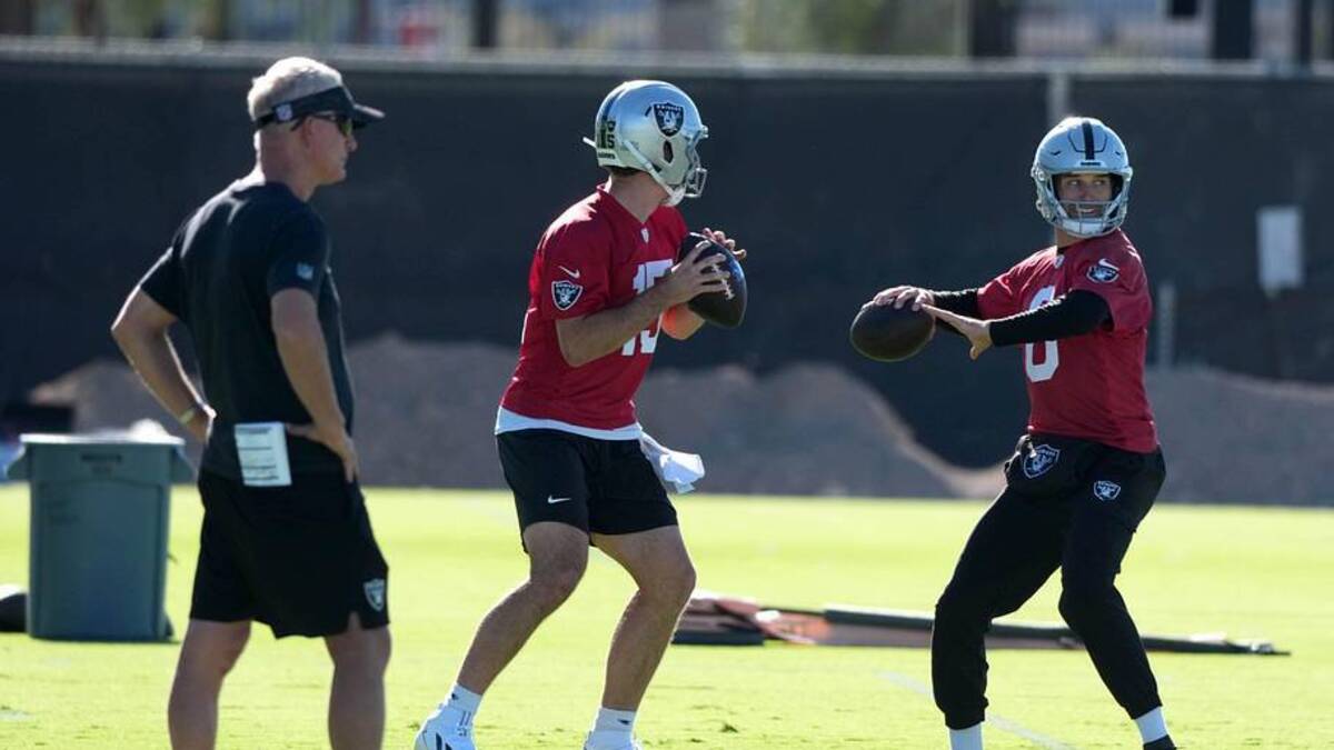  Jun 9, 2026; Henderson, NV, USA; Las Vegas Raiders quarterbacks Fernando Mendoza (15) and Kirk Cousins (8) throw the ball as assistant head coach Mike McCoy (left) watches during organized team activities at Intermountain Health Performance Center. Mandatory Credit: Kirby Lee-Imagn Images | Kirby Lee-Imagn Images 
