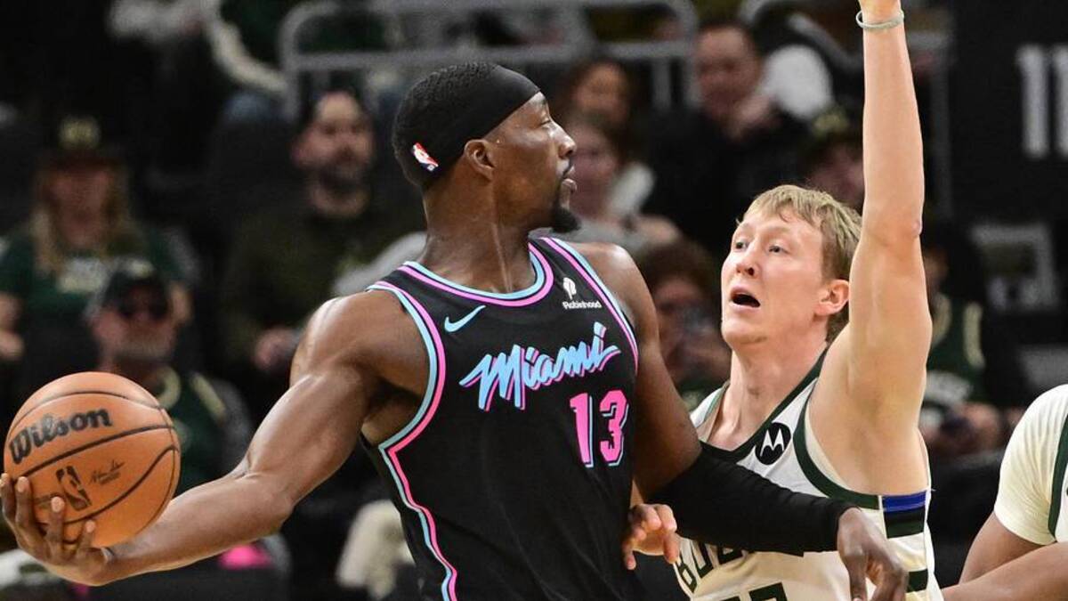  Feb 24, 2026; Milwaukee, Wisconsin, USA; Miami Heat forward Bam Adebayo (13) looks to pass the ball away from Milwaukee Bucks guard AJ Green (20) and center Myles Turner (3) in the first quarter at Fiserv Forum. Mandatory Credit: Benny Sieu-Imagn Images | Benny Sieu-Imagn Images 