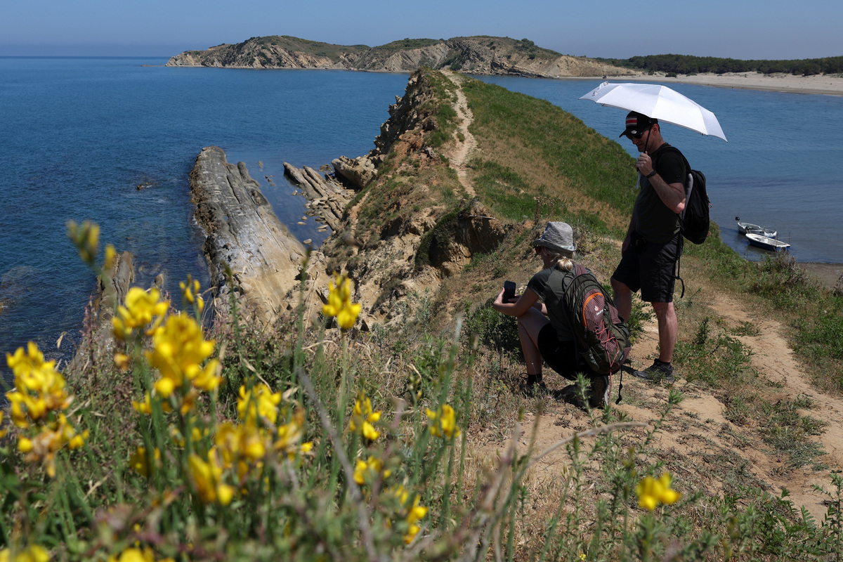 Tourists at the bay at the Vjosa-Narta Protected Area, where a luxury resort is planned by a company linked to Donald Trump's son-in-law, Jared Kushner, in Zvernec near Vlora, Albania, June 10, 2026. REUTERS/Florion Goga