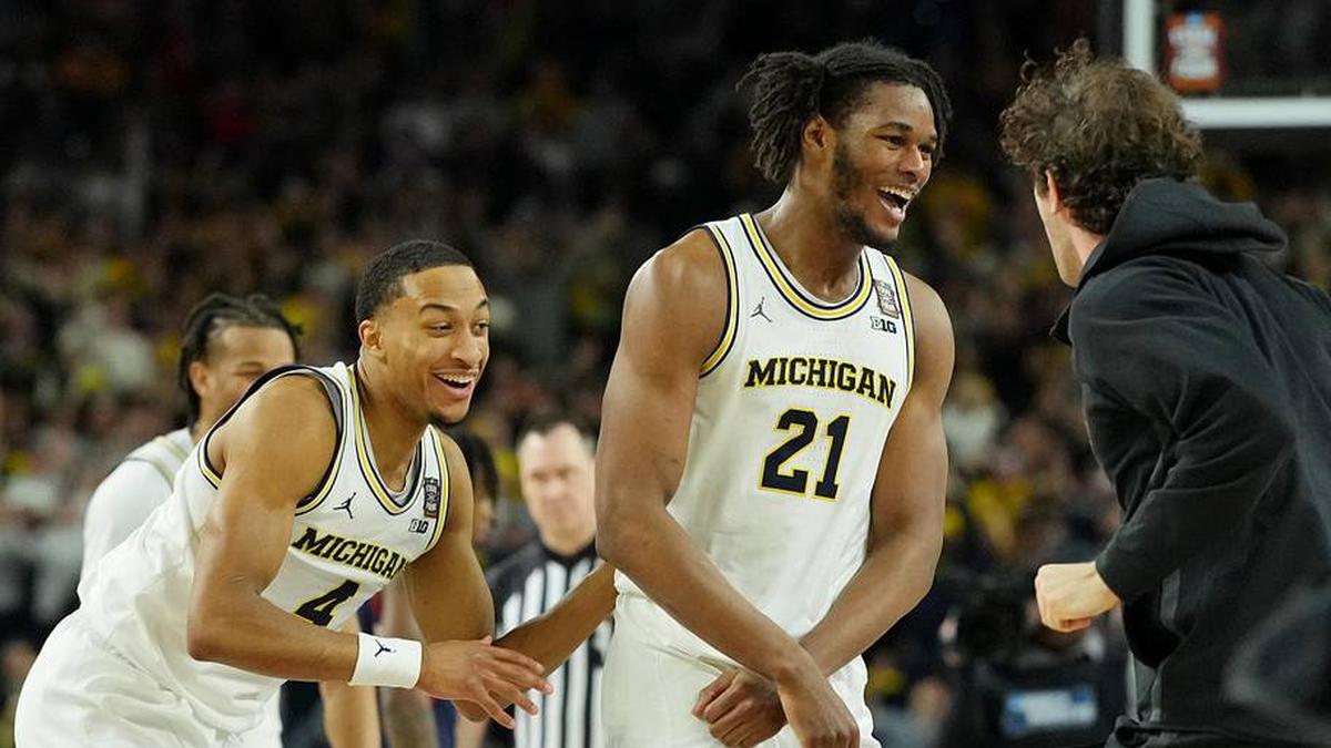  Apr 6, 2026; Indianapolis, IN, USA; Michigan Wolverines forward Morez Johnson Jr. (21) and guard Nimari Burnett (4) celebrate after their win against the UConn Huskies in the national championship of the Final Four of the men's 2026 NCAA Tournament between the and the Michigan Wolverines at Lucas Oil Stadium. Mandatory Credit: Bob Donnan-Imagn Images | Bob Donnan-Imagn Images 