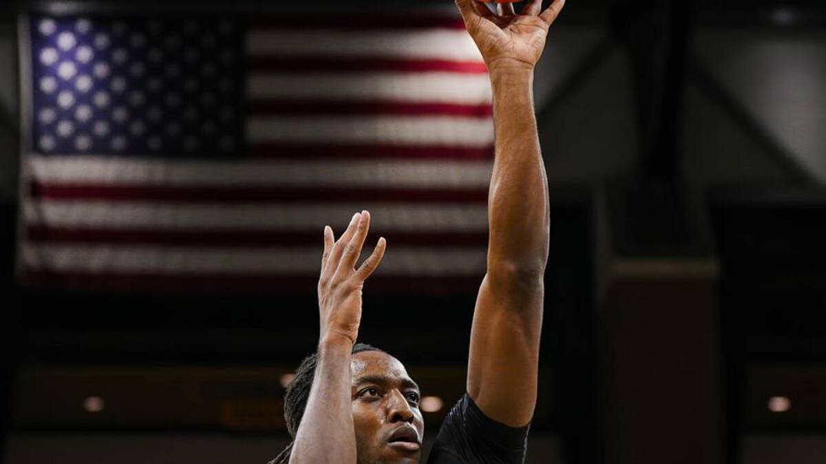  Nov 27, 2024; Columbia, Missouri, USA; Lindenwood Lions guard Jadis Jones (10) shoots the ball against Missouri Tigers guard Mark Mitchell (25) and center Josh Gray (33) during the first half at Mizzou Arena. Mandatory Credit: Jay Biggerstaff-Imagn Images | Jay Biggerstaff-Imagn Images 
