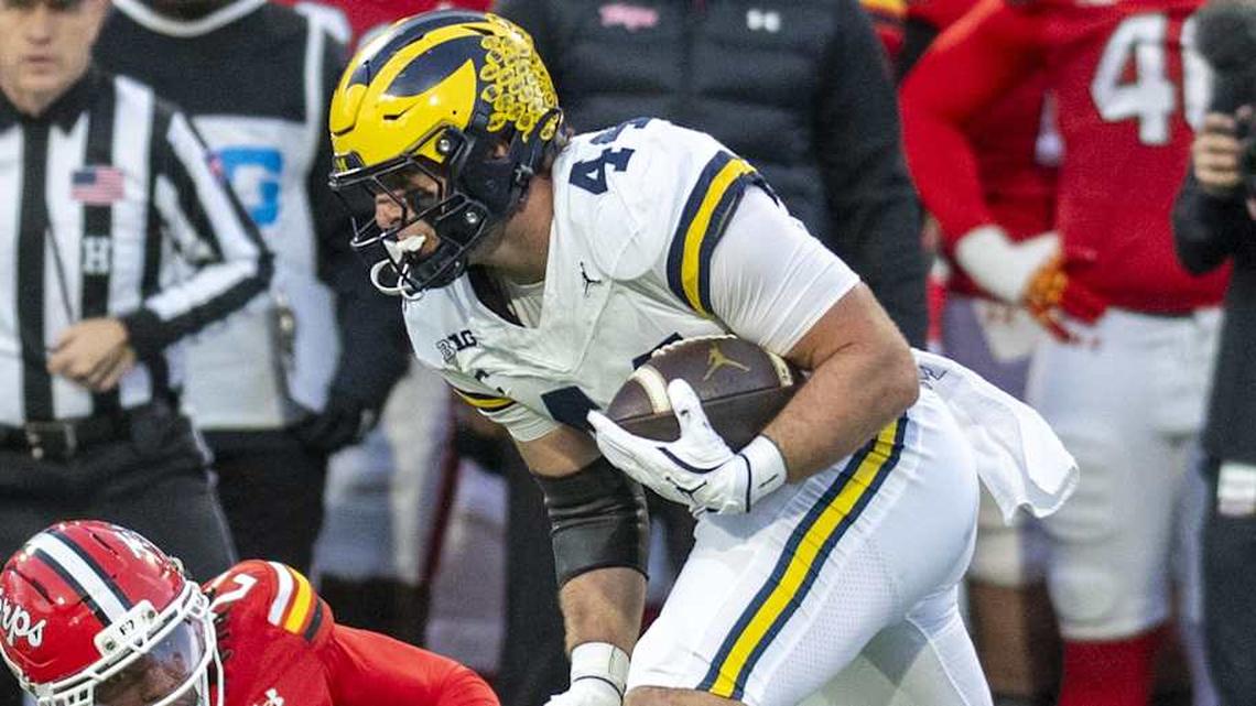  Nov 22, 2025; College Park, Maryland, USA; Michigan Wolverines tight end Max Bredeson (44) runs by Maryland Terrapins defensive back La'Khi Roland (27) after a first half catch at SECU Stadium. Mandatory Credit: Tommy Gilligan-Imagn Images | Tommy Gilligan-Imagn Images 
