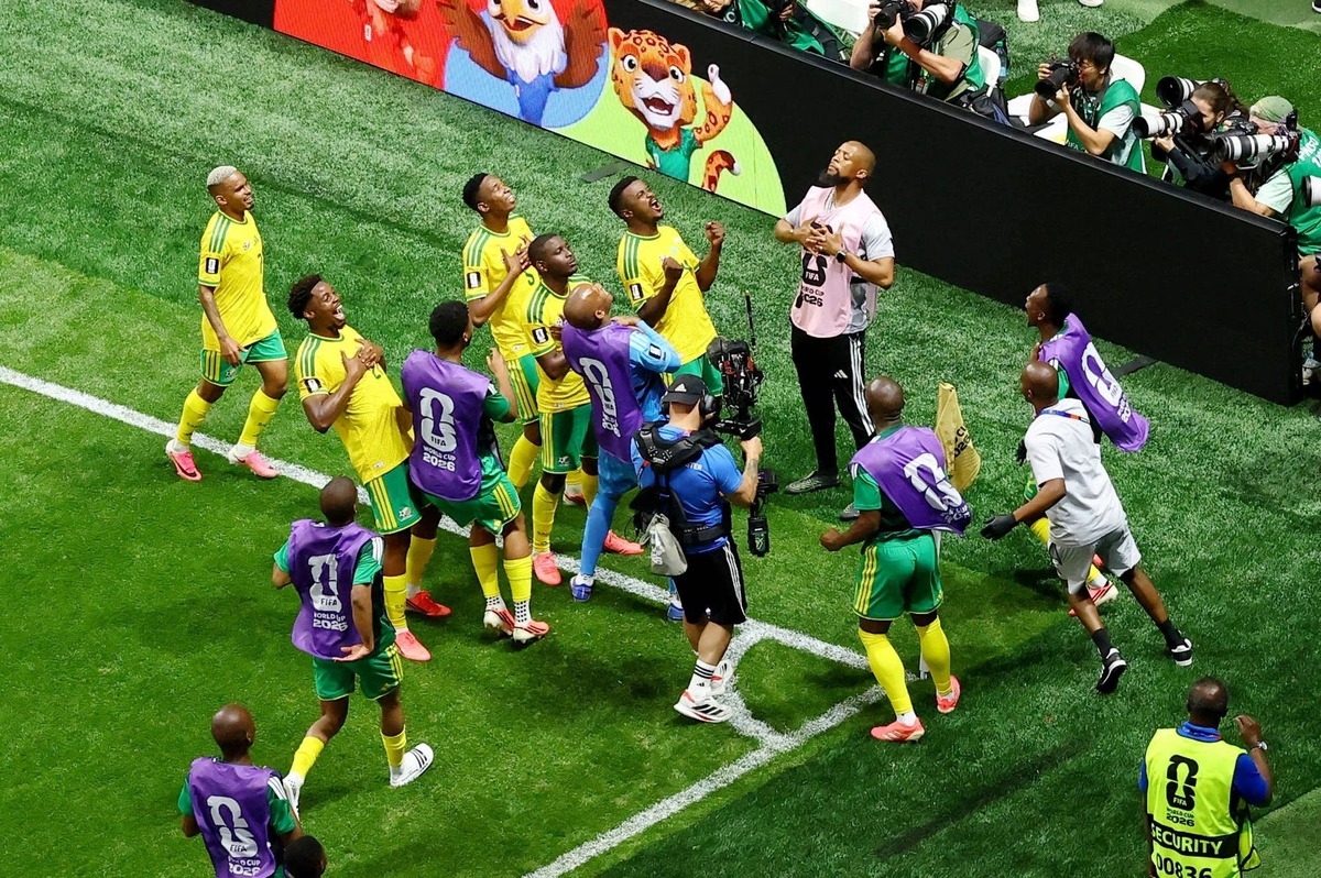  South African players celebrate after their first goal from the penalty spot. REUTERS - Bernadett Szabo