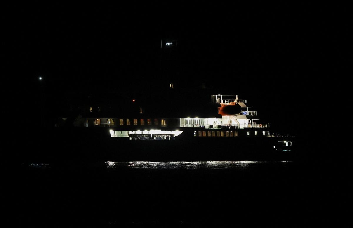 A boat approaches the port of Granadilla de Abona, where the cruise ship MV Hondius is expected to arrive, after being affected by a hantavirus outbreak, in Tenerife, Spain, May 10, 2026. REUTERS/Pedro Nunes