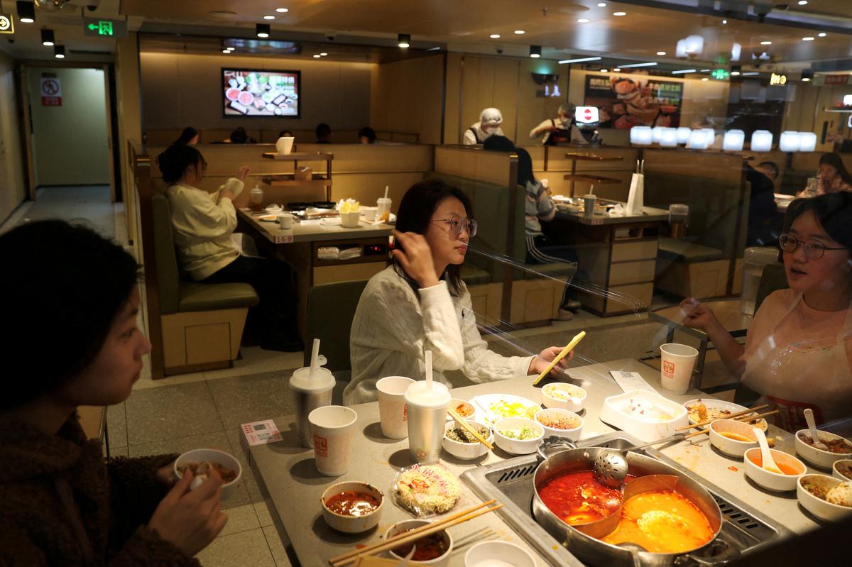 FILE PHOTO: Customers dine at the Hailao Huoguo in Beijing, China December 10, 2023. REUTERS/Tingshu Wang/File Photo