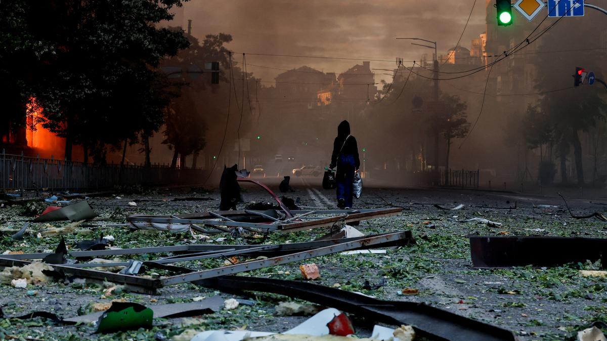 A person walks on a debris-scattered street in the aftermath of an overnight Russian missile and drone strike, amid Russia's attack on Ukraine, in Kyiv, Ukraine, May 24, 2026. REUTERS/Thomas Peter