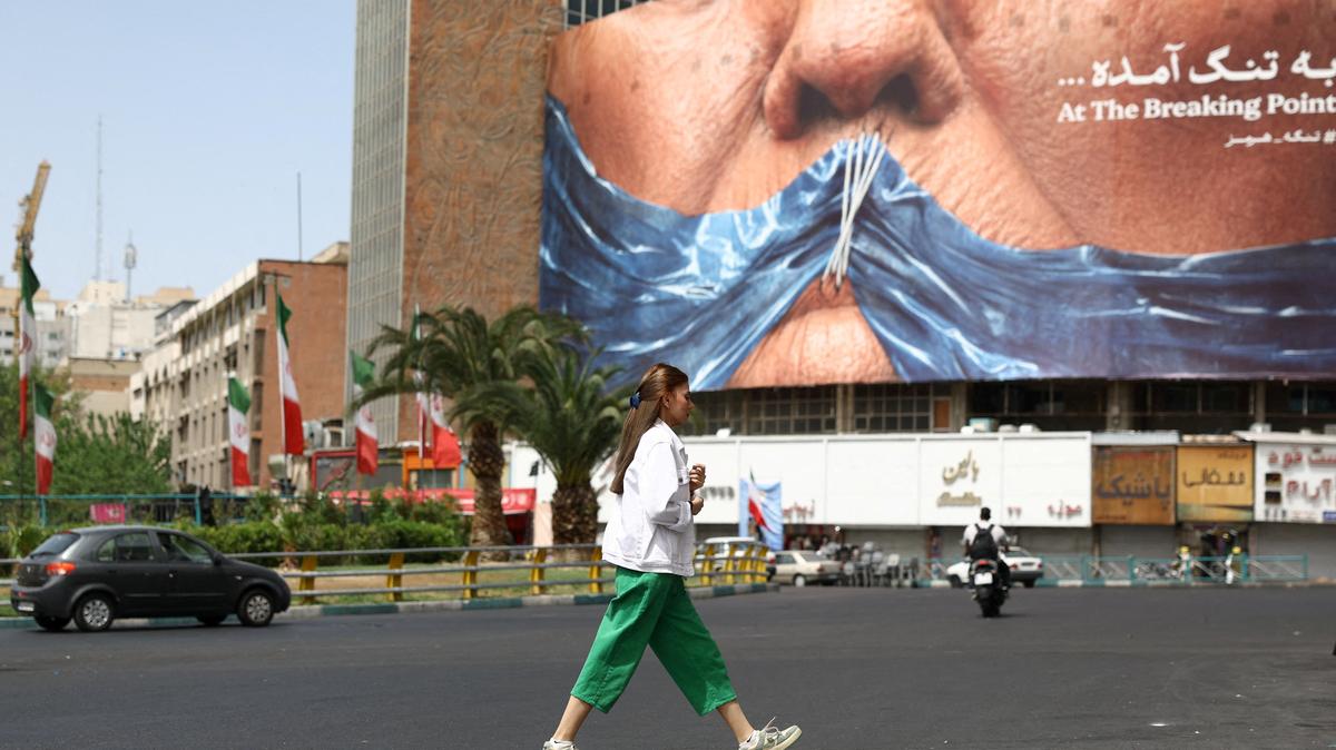 A woman walks past an anti-U.S. billboard depicting U.S. President Donald Trump and the Strait of Hormuz, in Tehran, Iran, May 8, 2026. Majid Asgaripour/WANA (West Asia News Agency) via REUTERS